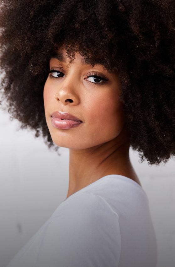 medical spa model with curly black hair