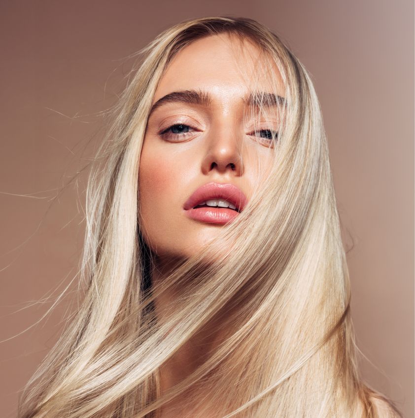medical spa model with long straight hair and blue eyes