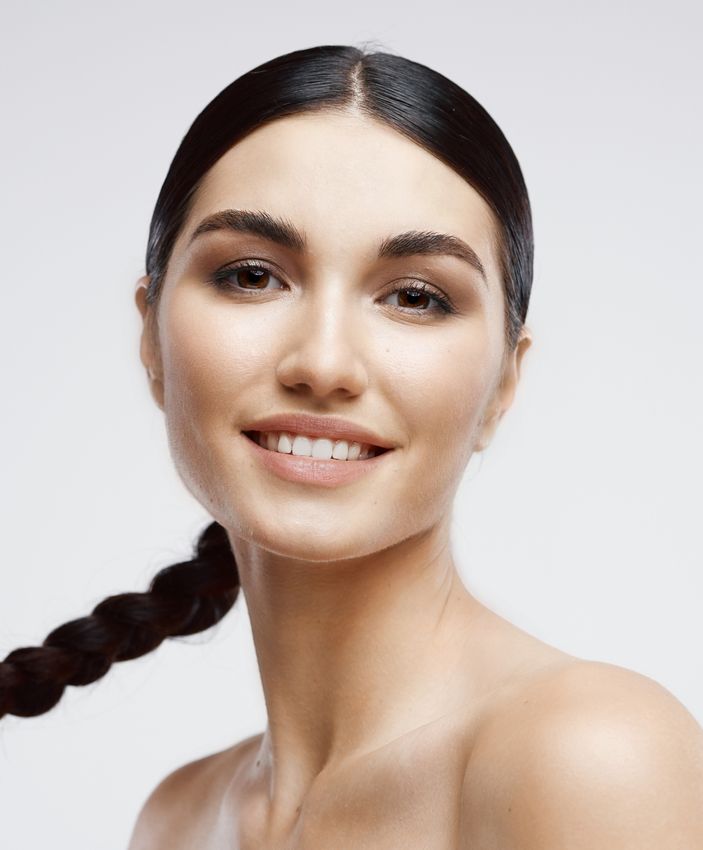 skin resurfacing ardmore feature - woman with dark hair in a braided pony tail