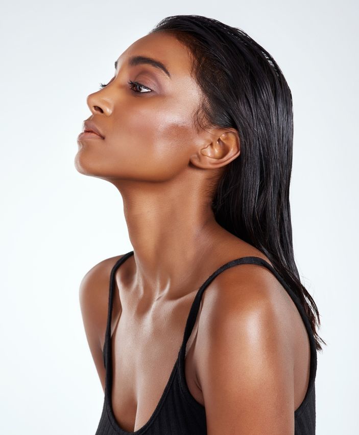 microneedling ardmore feature - woman with long dark hair wearing a black tank top
