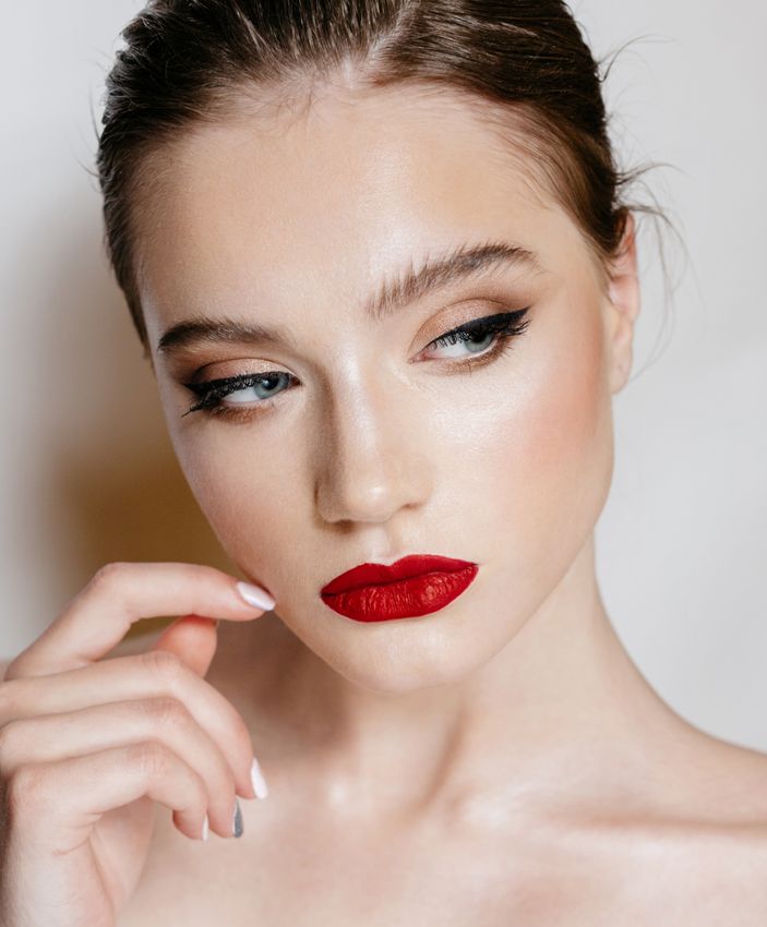 microneedling ardmore feature - woman with dark hair and red lipstick